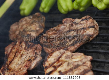 Grilling marinated meat on a charcoal grill