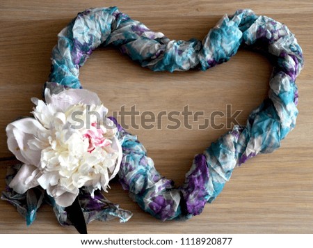 Multi-colored purple and blue thin scarf, twisted in the form of heart and 

white peony
