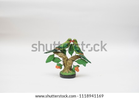 Showpiece of two parrots sitting on a tree branch