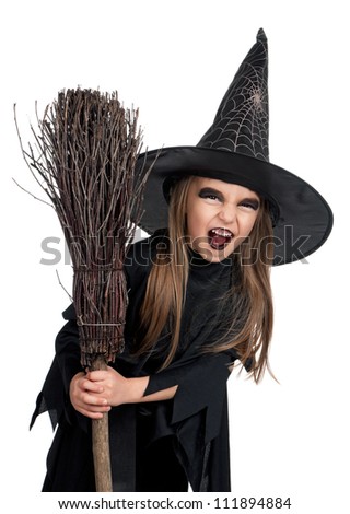 Portrait of little girl in black hat and black clothing with broom on white background