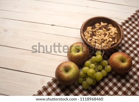 fruits and muesli on a wooden background