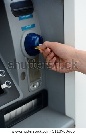 Business man put his credit card at the ATM