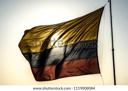 Colombia flag with the sun in the background. Colombian nationality
