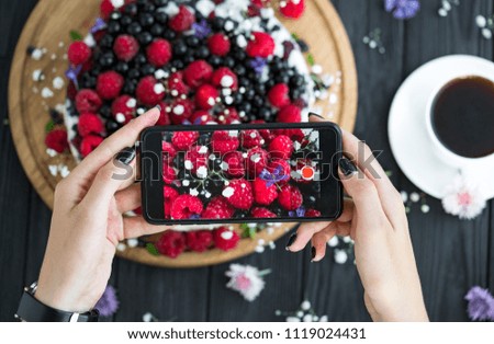 
photo of a fruit cake with a phone
