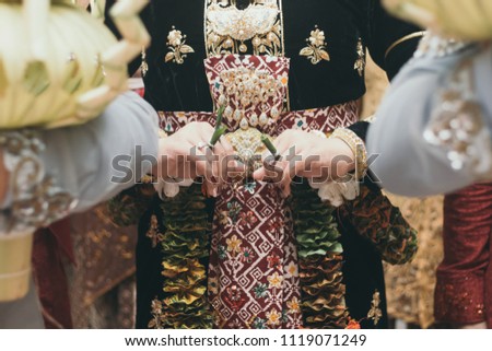 Hand of Javanase Woman doing Javanese Traditional Wedding Ceremony Balang Gantal