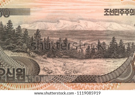 Fir trees with Mt. Paekdu (Baekdu, Paektu, Changbai) and Baekdudaegan mountain range in the background. Portrait from North Korea 50 Won 1992 Banknotes.