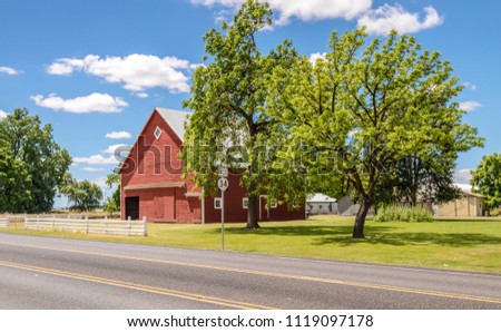 Red barn in a country road Willamette valley Oregon.
