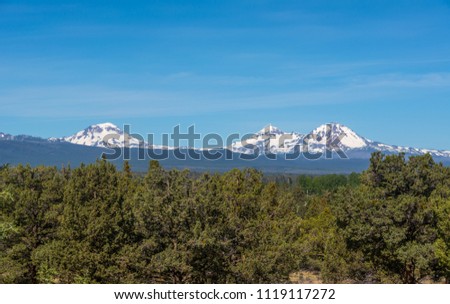Three Sisters, Cascade Range volcanoes in Oregon, photographed from about 2 miles north of Tumalo, Oregon. The volcanoes are unusually close together and all about the same elevation, 10,000+ feet.