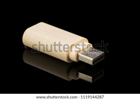 Wood USB flash drive on a black background. Isolated background