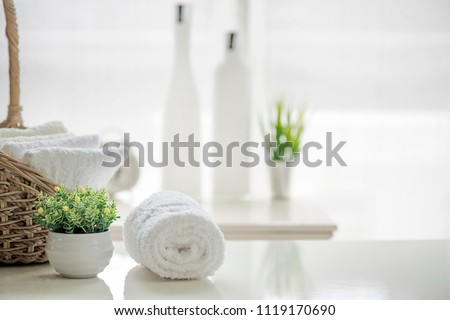 White towels on white table with copy space on blurred bathroom background. For product display montage. Royalty-Free Stock Photo #1119170690