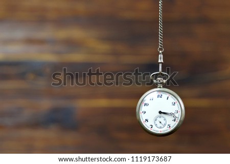 Vintage pocket watch on wooden background with copy space