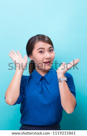 Surprised woman on isolated blue background