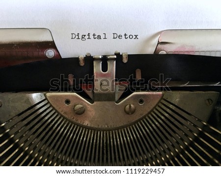 Digital Detox, heading title typewritten on white paper in black ink on vintage manual typewriter machine
