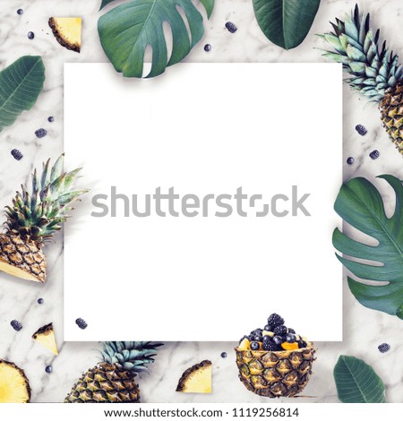 Frame of tropical leaves and pineapple. Tropical concept. Top view. Copy space.  Flat lay. Mock-up