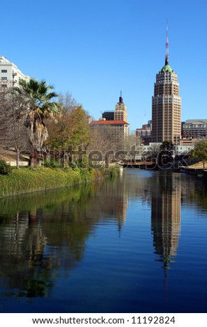 a riverwalk reflection of a tower in the San Antonio skyline
