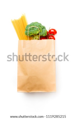 Photo of paper bag with broccoli, spaghetti and tomatoes