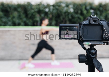 Young female vlogger recording content for her video blog. Fitness and healthy lifestyle concept. 
