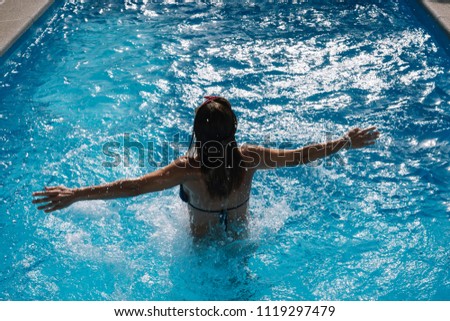 Woman inside the pool enjoying happy