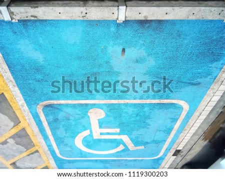Sign of wheelchair on the ground, Disabled parking sign marking on the floor in Thailand.