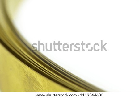 Golden brass metal stripon white background, selective focus