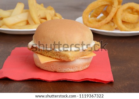 closeup of fillet fish sandwich on red napkin