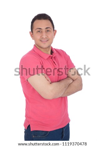 Young man standing with crossed arms in a casual outfit, isolated on a white background.