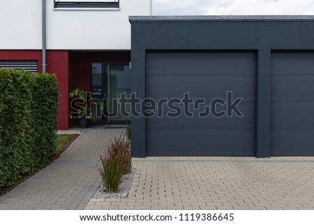 modern black garage in suburban street in south germany countryside near city stuttgart Royalty-Free Stock Photo #1119386645