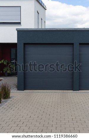 modern black garage in suburban street in south germany countryside near city stuttgart Royalty-Free Stock Photo #1119386660