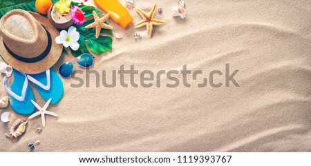 Straw hat with a exotic cocktail and sunglasses on sand beach. Summer Holidays concept Royalty-Free Stock Photo #1119393767