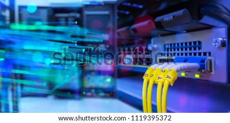 network gigabit switch and fiber optic cable and lighting of fiber optics on background in data center room Royalty-Free Stock Photo #1119395372