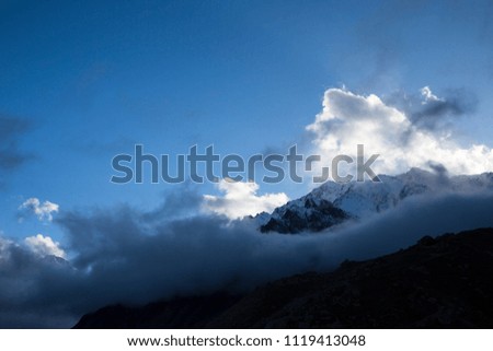 Mountain landscape. Tops in white clouds, the Beautiful view of the picturesque gorge, a panorama with high mountains. The nature of the North Caucasus, rest in mountains