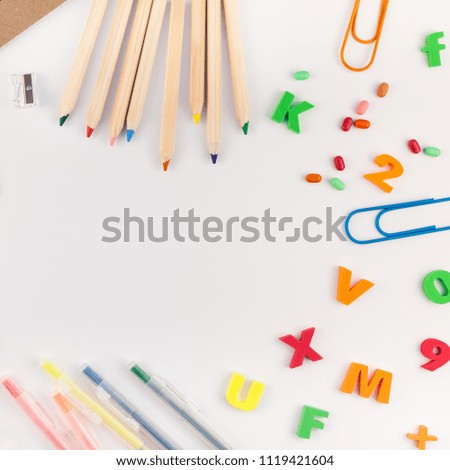 Square flat lay back to school concept with color school and office supplies on white table background with copy space, frame, template for text or design