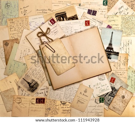 old letters, french post cards and empty open book. nostalgic vintage background Royalty-Free Stock Photo #111943928