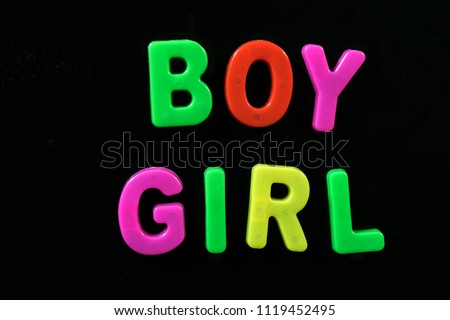 English letters in black background are the words "boy and girl", glowing, white, red