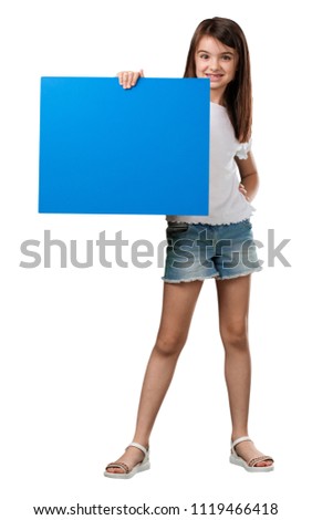 Full body little girl cheerful and motivated, showing an empty poster where you can show a message, communication concept