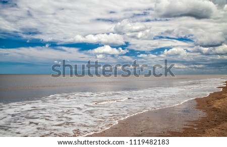 rolling clouds and frothy sea at mablethorpe beach, Lincolnshire coast, England 4th June 2017