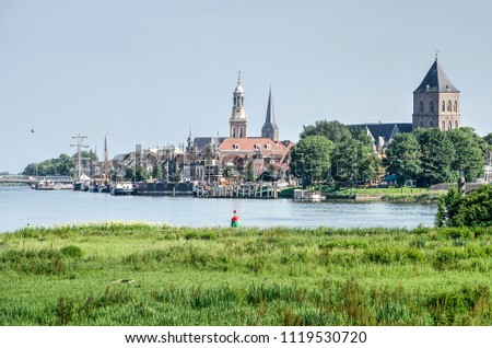 View across the river IJssel and its floodplain towards the old Hanze city of Kampen, The Netherlands Royalty-Free Stock Photo #1119530720