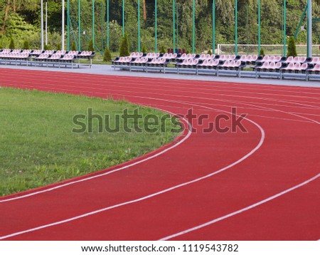 Red treadmill at the stadium. Element of a sports complex. Outdoor coating for sports. A place for competitions in athletics