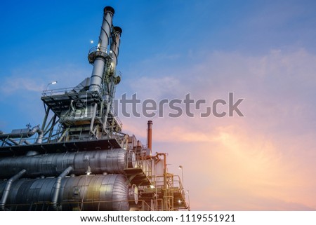 Industrial furnace and heat exchanger cracking hydrocarbons in factory on blue sky sunset background, Close up of equipment in petrochemical plant at evening Royalty-Free Stock Photo #1119551921