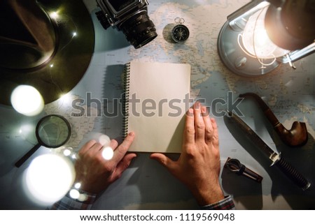 Adventure planning near gas lamp flat lay. Atmospheric old gear on map. Traveler, explorer hands in frame holding notepad. Exploring, hiking empty space, postcard, template.