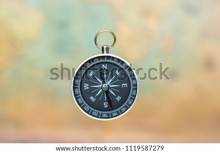 compass on a blurred background of an old map