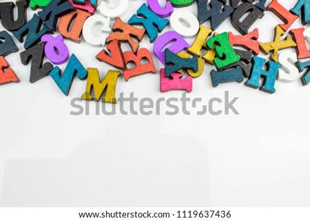 Mixed colorful English Letters on a white background with a copy space
