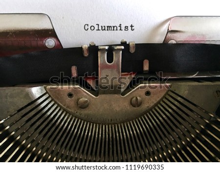 Columnist, occupation title typed in black ink on vintage manual typewriter machine