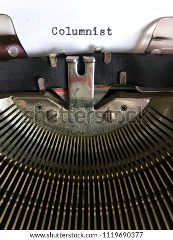 Columnist, occupation title typed in black ink on vintage manual typewriter machine