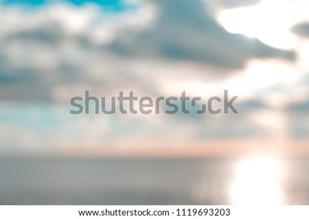 Blurred sunset beach with bokeh sunny light water abstract background. Travel concept. Retro style colors.