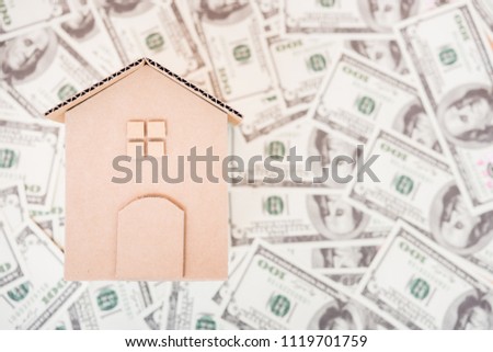 House cardboard model on dollar money, currency money concept