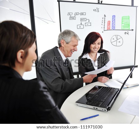 Business meeting with board presentation diagrams