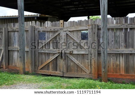 A gate around a horse arena on a farm