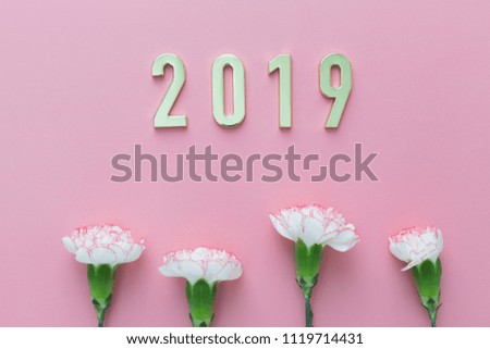 White flowers on pink paper background and Gold metal letter of "2019".Vintage tone.
