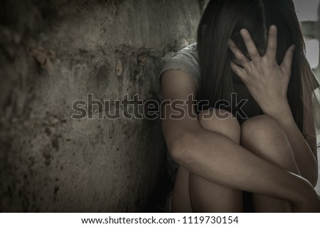 Women sit sad because of being tempted to rape , anti-trafficking and stopping violence against women, International Women's Day Royalty-Free Stock Photo #1119730154